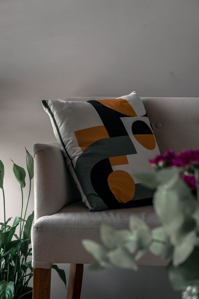 Mastering the First Impression: Your intriguing post title goes here Stylish armchair with geometric cushion adds elegance to home decor.